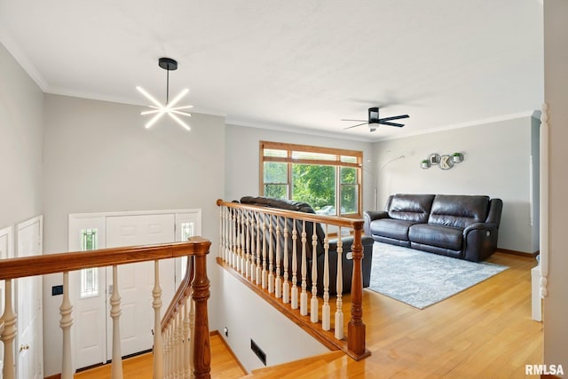 5760 Jenny Ln, Bettendorf, IA 52722 - hallway with an upstairs landing, light wood-style floors, crown molding, and a chandelier