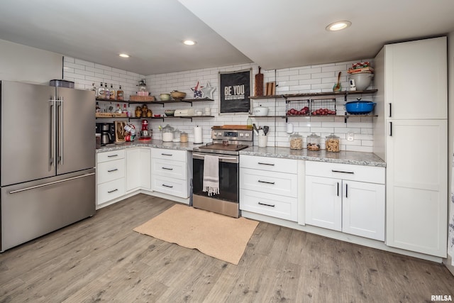 521 E Park St, Geneseo, IL 61254 - kitchen with stainless steel appliances, open shelves, tasteful backsplash, white cabinetry, and recessed lighting