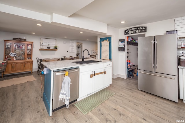 521 E Park St, Geneseo, IL 61254 - kitchen with stainless steel appliances, a sink, white cabinetry, light wood-style flooring, and recessed lighting
