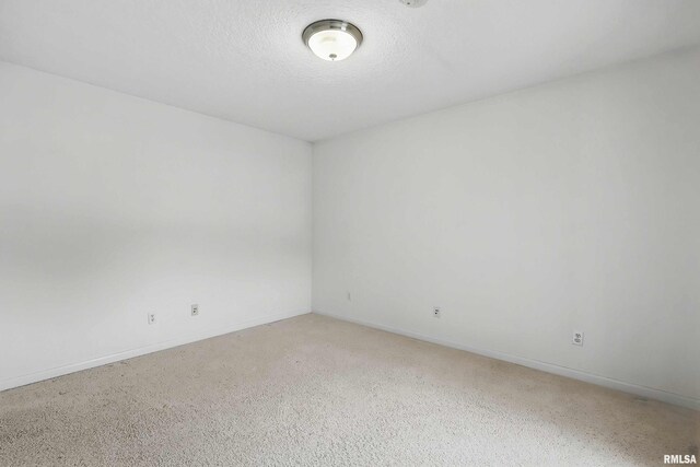 108 N Howard Ln, Long Grove, IA 52756 - unfurnished room featuring baseboards and a textured ceiling