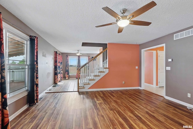 108 N Howard Ln, Long Grove, IA 52756 - foyer with ceiling fan, a textured ceiling, wood finished floors, stairway, and baseboards
