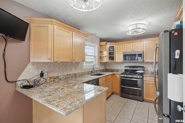 108 N Howard Ln, Long Grove, IA 52756 - kitchen featuring stainless steel appliances, a peninsula, light brown cabinets, a sink, and decorative backsplash