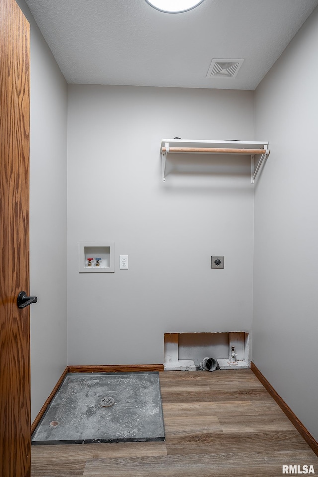 4260 Sapphire Ln, Bettendorf, IA 52722 - laundry area featuring electric dryer hookup, wood finished floors, hookup for a washing machine, and baseboards