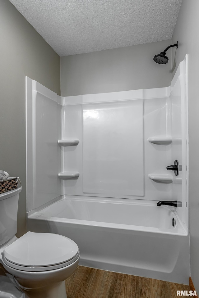 4260 Sapphire Ln, Bettendorf, IA 52722 - bathroom featuring toilet, a textured ceiling, wood finished floors, and shower / tub combination