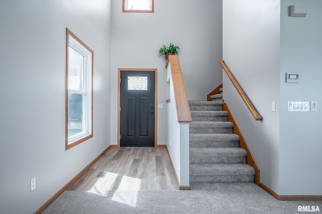 4260 Sapphire Ln, Bettendorf, IA 52722 - foyer entrance featuring stairs, baseboards, and wood finished floors