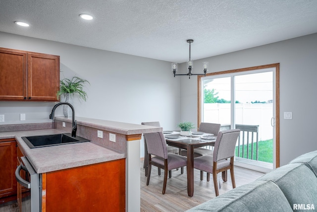 4260 Sapphire Ln, Bettendorf, IA 52722 - dining space featuring light wood-type flooring, a textured ceiling, a chandelier, and recessed lighting