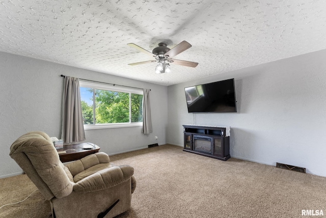 1409 10th Ave, Viola, IL 61486 - carpeted living area featuring ceiling fan, a textured ceiling, baseboards, and a fireplace