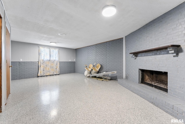 1409 10th Ave, Viola, IL 61486 - basement featuring wainscoting, a fireplace, and brick wall