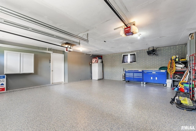 1409 10th Ave, Viola, IL 61486 - garage featuring a garage door opener, freestanding refrigerator, and water heater