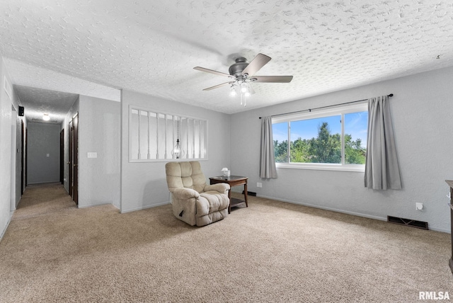 1409 10th Ave, Viola, IL 61486 - sitting room featuring carpet flooring, ceiling fan, a textured ceiling, and baseboards