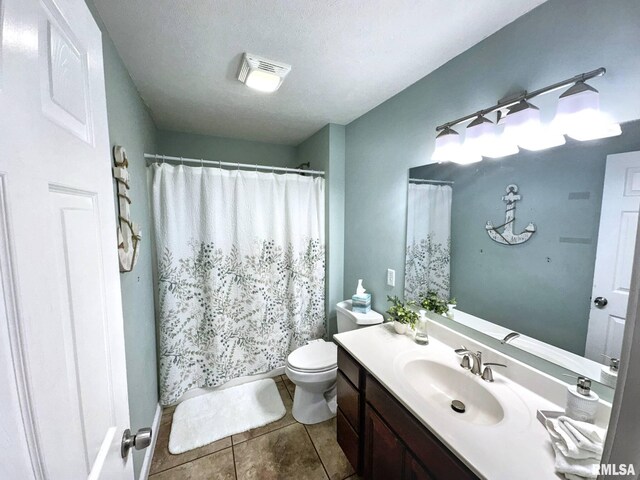 203 Breeze Dr, Carterville, IL 62918 - full bathroom featuring toilet, vanity, tile patterned flooring, a shower with curtain, and a textured ceiling