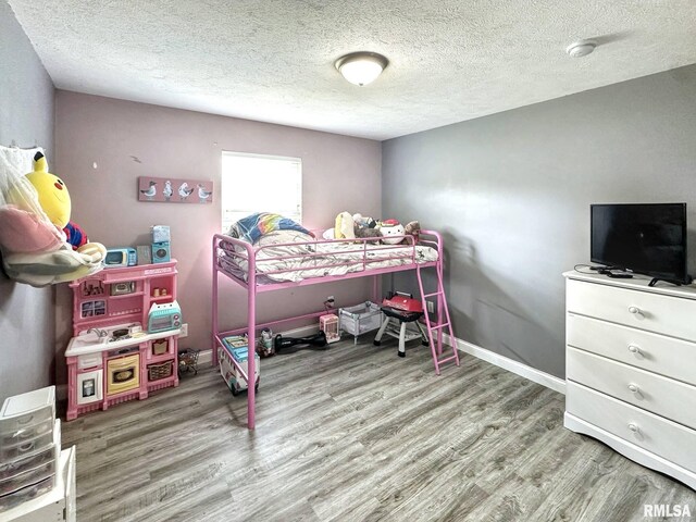203 Breeze Dr, Carterville, IL 62918 - bedroom with wood finished floors and a textured ceiling