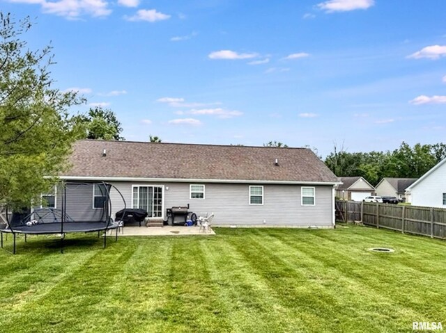 203 Breeze Dr, Carterville, IL 62918 - rear view of house featuring a trampoline and a patio area