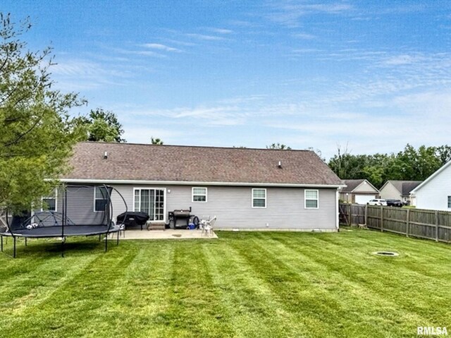 203 Breeze Dr, Carterville, IL 62918 - back of house featuring a trampoline and a patio area