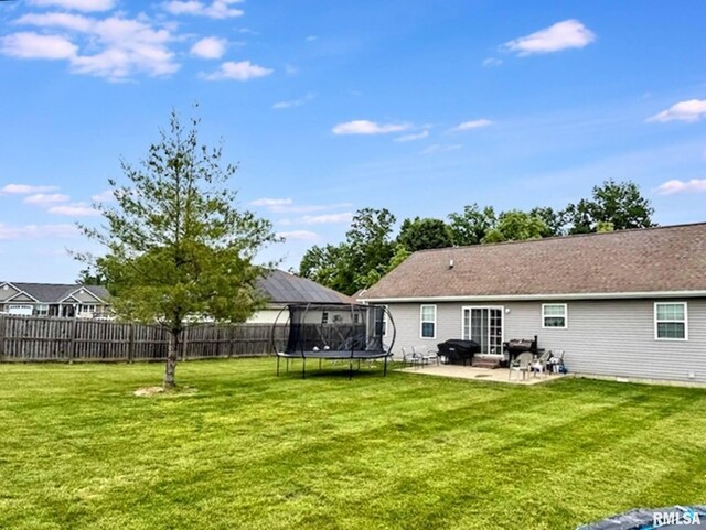 203 Breeze Dr, Carterville, IL 62918 - back of property featuring a trampoline and a patio area