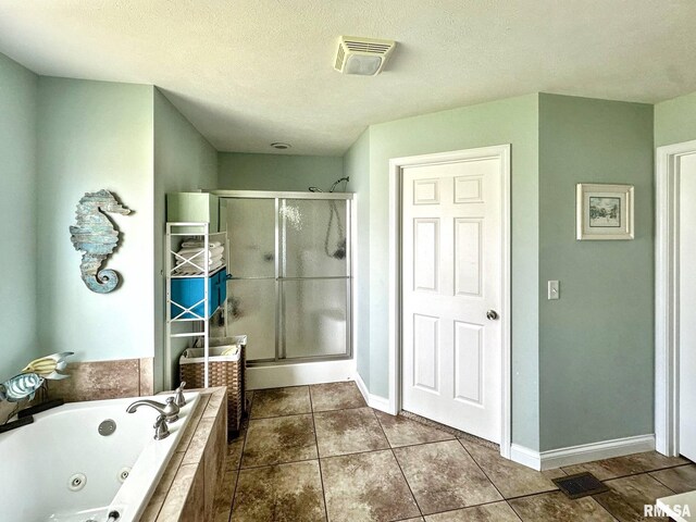 203 Breeze Dr, Carterville, IL 62918 - bathroom with a shower stall, a whirlpool tub, tile patterned floors, baseboards, and a textured ceiling