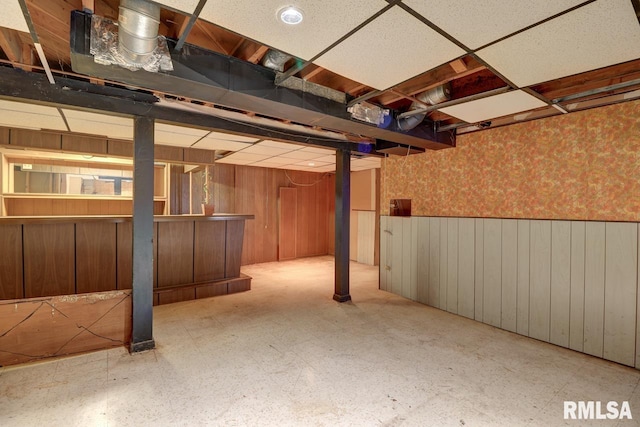 1148 Briarcliff Ln, Clinton, IA 52732 - finished below grade area with tile patterned floors, wallpapered walls, wainscoting, a dry bar, and wood walls