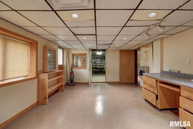 1148 Briarcliff Ln, Clinton, IA 52732 - below grade area featuring a paneled ceiling, recessed lighting, and baseboards