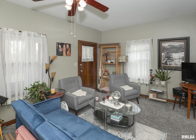 1036 30th St, Rock Island, IL 61201 - carpeted living room featuring ceiling fan and baseboards