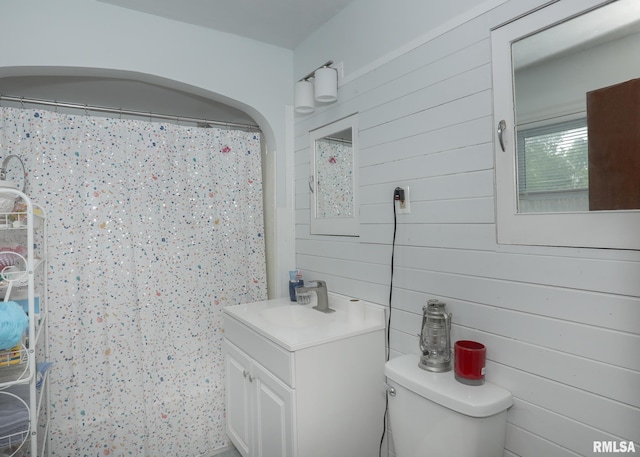 1036 30th St, Rock Island, IL 61201 - full bathroom with vanity, toilet, wood walls, and a shower with curtain