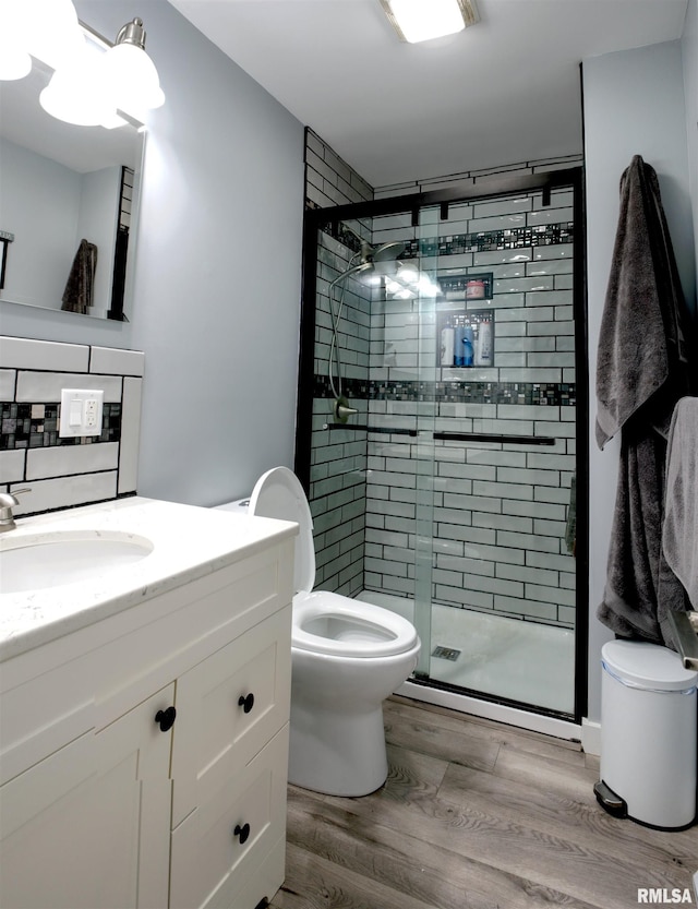 2303 Dunham St, Clinton, IA 52732 - full bathroom featuring toilet, vanity, a shower stall, and wood finished floors