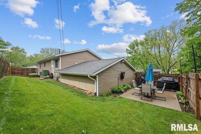 237 Colony Dr, Davenport, IA 52806 - back of property with a patio area and roof with shingles