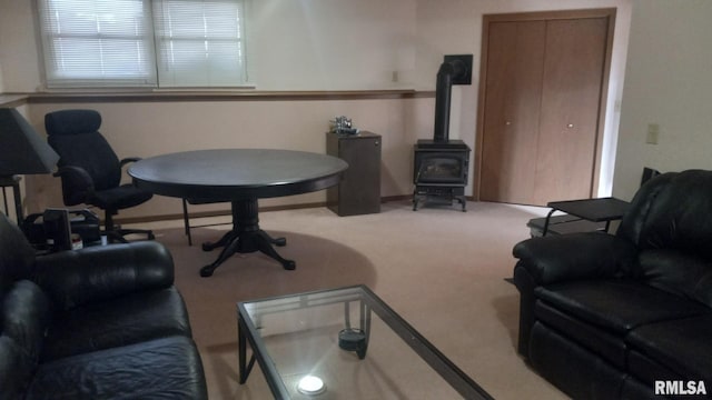 1827 13th Ave, Moline, IL 61265 - living room with carpet floors, a wood stove, and baseboards