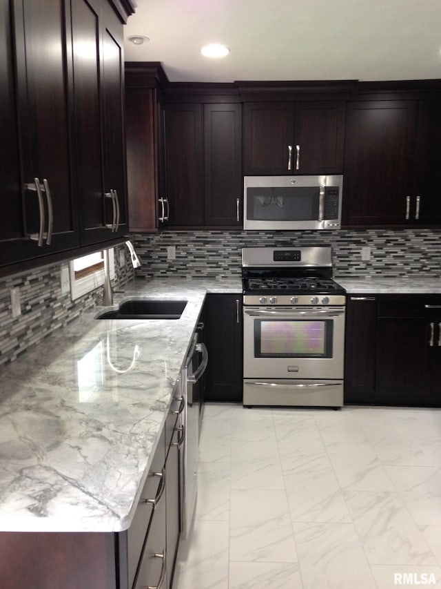 1827 13th Ave, Moline, IL 61265 - kitchen featuring stainless steel appliances, light marble finish flooring, a sink, tasteful backsplash, and light stone countertops