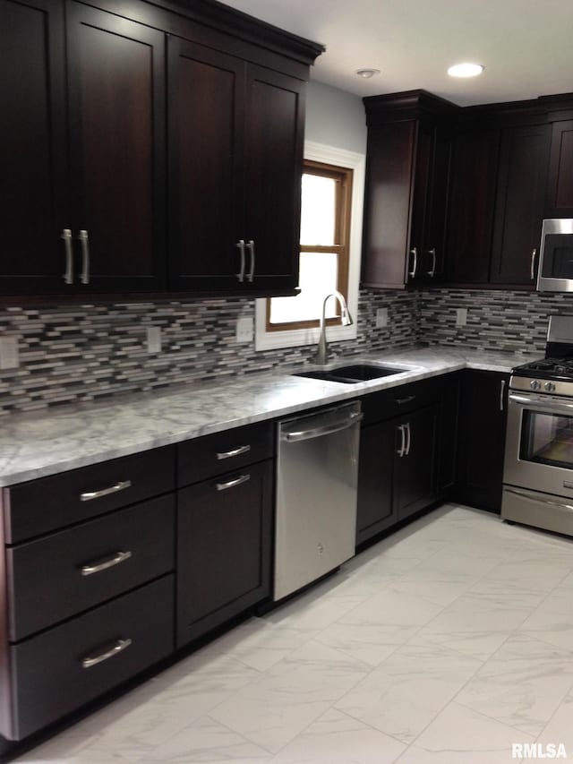 1827 13th Ave, Moline, IL 61265 - kitchen with stainless steel appliances, a sink, decorative backsplash, light stone countertops, and recessed lighting