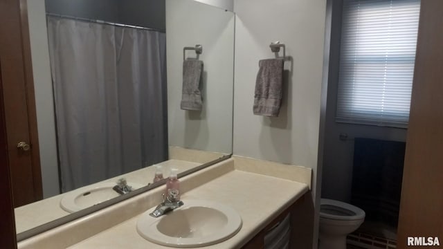 1827 13th Ave, Moline, IL 61265 - bathroom featuring vanity, toilet, and curtained shower