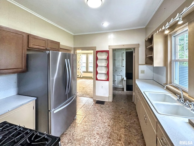 1010 W White St, Marion, IL 62959 - kitchen with a sink, freestanding refrigerator, ornamental molding, light countertops, and brown cabinets