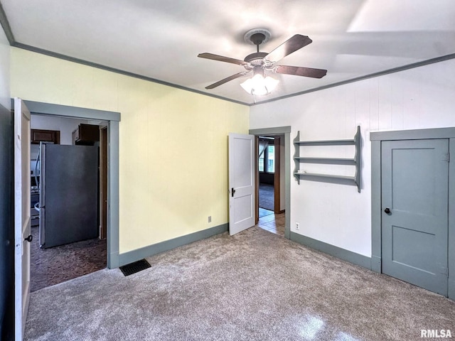 1010 W White St, Marion, IL 62959 - unfurnished bedroom featuring freestanding refrigerator, carpet, crown molding, baseboards, and a ceiling fan