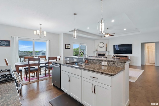 4241 Colorado Dr, Bettendorf, IA 52722 - kitchen with a sink, stainless steel dishwasher, a tray ceiling, open floor plan, and a ceiling fan