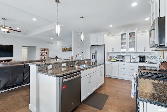 4241 Colorado Dr, Bettendorf, IA 52722 - kitchen featuring appliances with stainless steel finishes, a sink, open floor plan, wood finished floors, and a ceiling fan