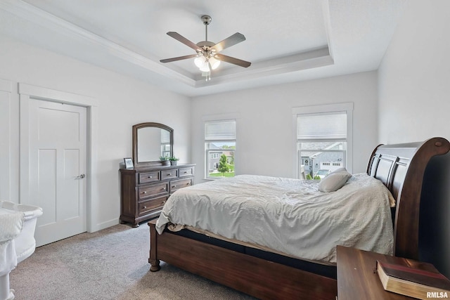 4241 Colorado Dr, Bettendorf, IA 52722 - bedroom featuring a tray ceiling, light colored carpet, and ceiling fan