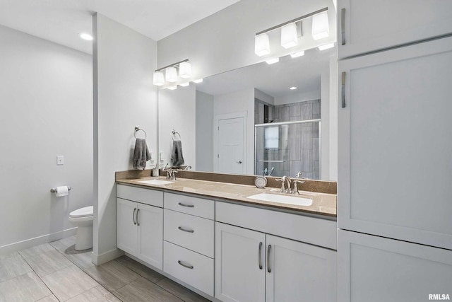 4241 Colorado Dr, Bettendorf, IA 52722 - full bath featuring double vanity, a stall shower, toilet, baseboards, and recessed lighting