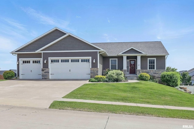 4241 Colorado Dr, Bettendorf, IA 52722 - craftsman-style house featuring an attached garage, stone siding, driveway, and a front lawn