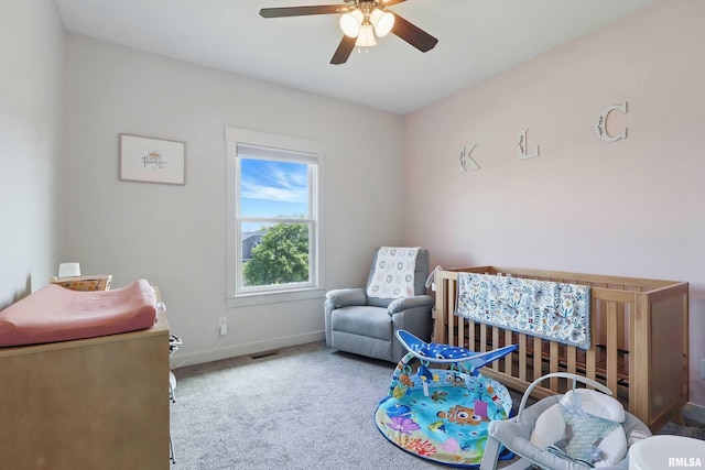 4241 Colorado Dr, Bettendorf, IA 52722 - bedroom featuring carpet, baseboards, a crib, and ceiling fan