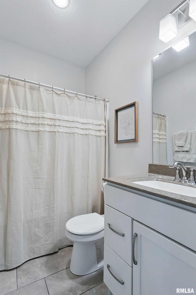 4241 Colorado Dr, Bettendorf, IA 52722 - full bathroom with toilet, vanity, and tile patterned flooring