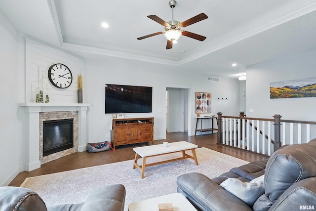 4241 Colorado Dr, Bettendorf, IA 52722 - living room featuring a ceiling fan, a tray ceiling, wood finished floors, recessed lighting, and a brick fireplace