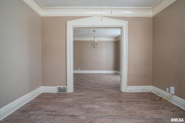 1415 Pershing Ave, Davenport, IA 52803 - empty room with wood finished floors, ornamental molding, baseboards, and a chandelier