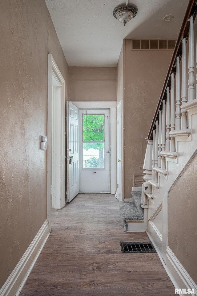 1415 Pershing Ave, Davenport, IA 52803 - entrance foyer with wood finished floors, stairs, baseboards, and a textured wall