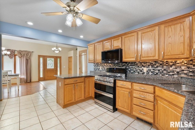 859 45th Ave, East Moline, IL 61244 - kitchen featuring stainless steel appliances, a chandelier, light tile patterned flooring, a peninsula, and tasteful backsplash