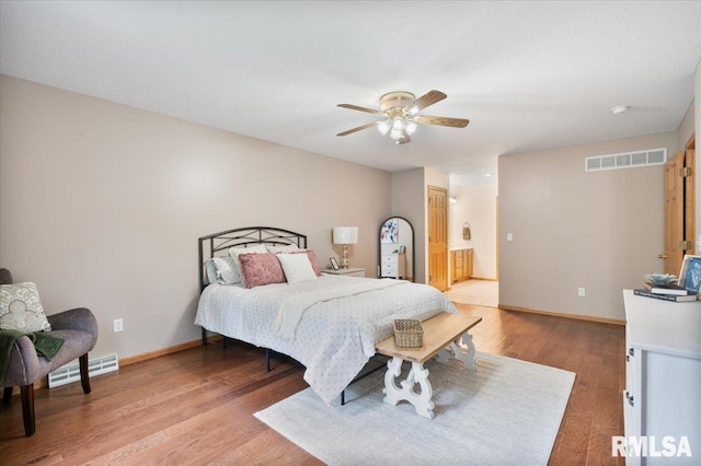 859 45th Ave, East Moline, IL 61244 - bedroom with light wood-type flooring, baseboards, and ceiling fan