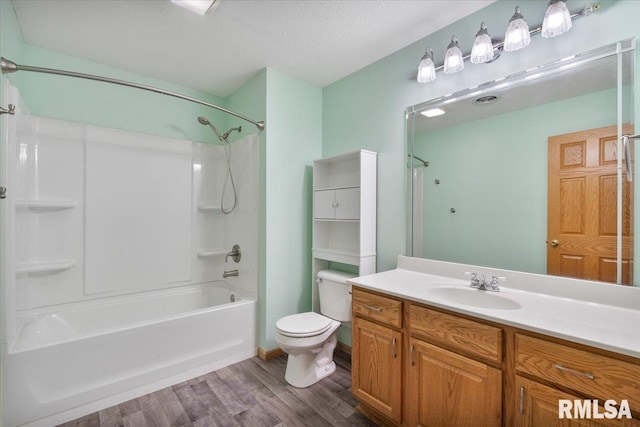 859 45th Ave, East Moline, IL 61244 - full bath featuring wood finished floors, vanity, shower / bath combination, toilet, and a textured ceiling
