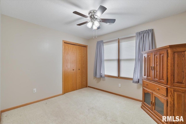 859 45th Ave, East Moline, IL 61244 - unfurnished bedroom featuring light colored carpet, baseboards, a closet, and ceiling fan