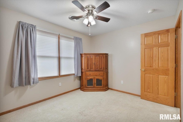 859 45th Ave, East Moline, IL 61244 - unfurnished bedroom featuring light carpet, baseboards, and ceiling fan