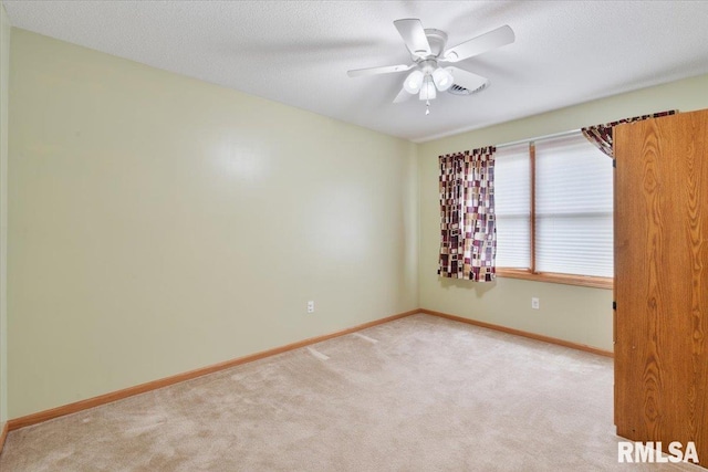 859 45th Ave, East Moline, IL 61244 - spare room with carpet flooring, baseboards, and a ceiling fan