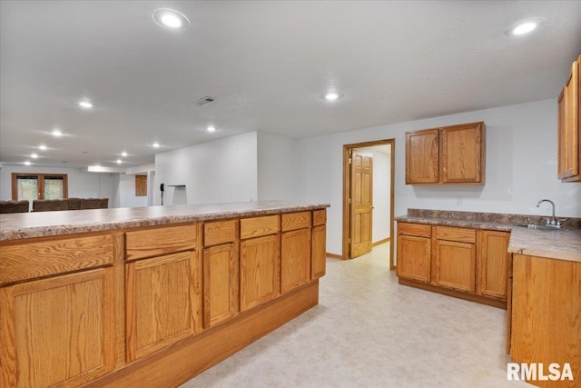 859 45th Ave, East Moline, IL 61244 - kitchen featuring a sink, recessed lighting, and brown cabinetry