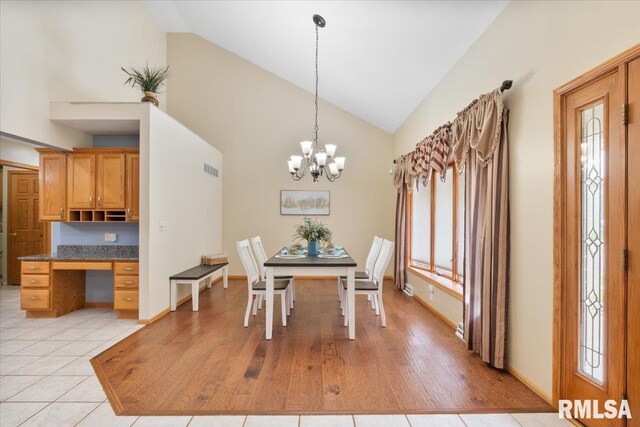 859 45th Ave, East Moline, IL 61244 - dining area featuring high vaulted ceiling, a chandelier, and light wood-style floors